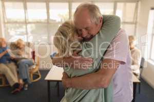 Senior couple embracing each other at nursing home