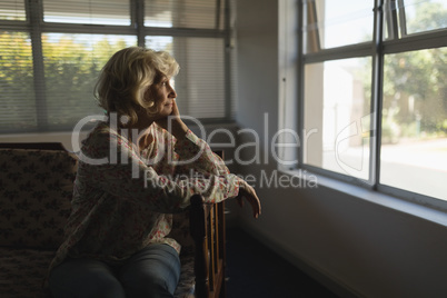 Senior woman relaxing in living room at nursing home