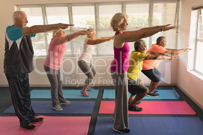 Group of senior people performing exercise at home