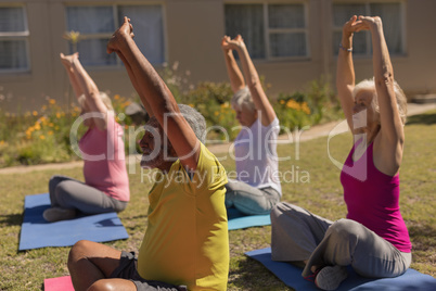 Senior people performing yoga in the park