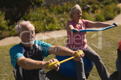 Senior man and woman exercising woman the