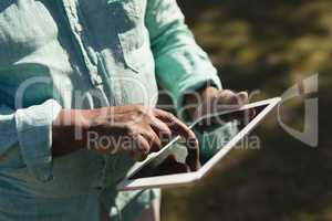 Senior man using digital tablet in the nursing park