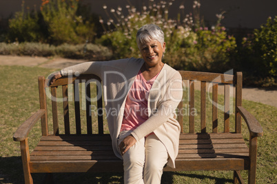 Senior woman sitting on a bench in the park