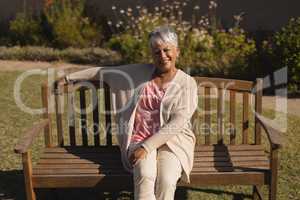 Senior woman sitting on a bench in the park