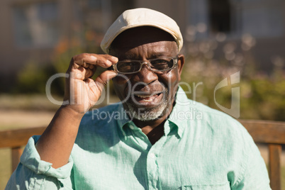 Senior man in spectacle smiling in the park