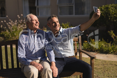 Senior men taking selfie with mobile phone in the park