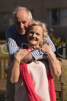 Senior couple embracing each other in the park