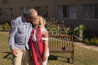 Senior couple kissing each other in the park