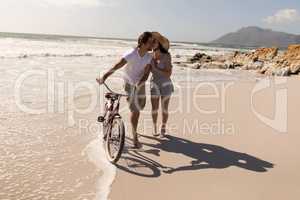 Young woman kissing on man cheek at beach