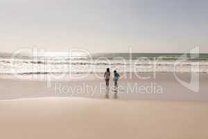 Siblings standing on beach