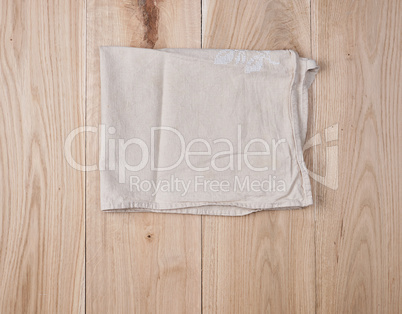 folded white towel on brown wooden background
