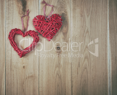 two red hearts on a wooden background of oak boards