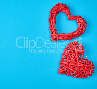 two wicker red hearts on a blue background