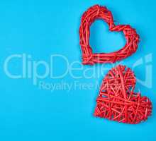 two wicker red hearts on a blue background