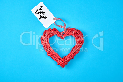 red wicker heart with paper tag on ribbon