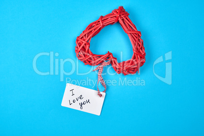 red wicker heart with paper tag on ribbon