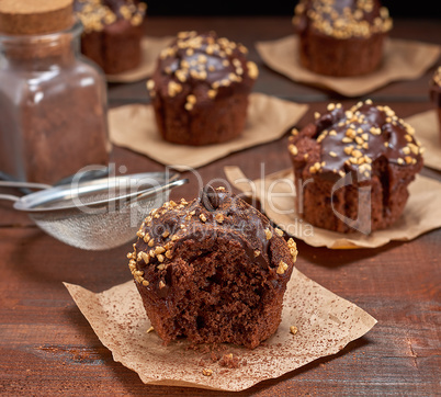 chocolate muffins on a brown wooden background