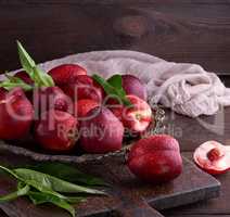 red ripe peaches nectarine in an iron plate