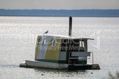 Floating sauna with seagul in the sea.