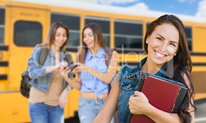 Young Female Student with Books Near School Bus