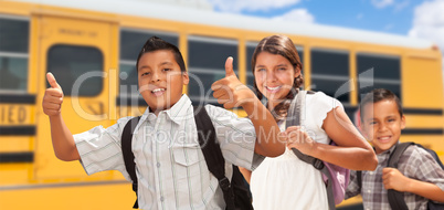 Young Hispanic Boys and Girl Walking Near School Bus