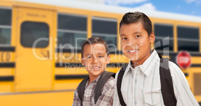Young Hispanic Boys Walking Near School Bus
