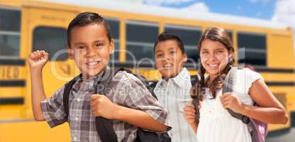 Young Hispanic Boys and Girl Walking Near School Bus