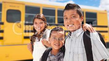 Young Hispanic Boys and Girl Walking Near School Bus