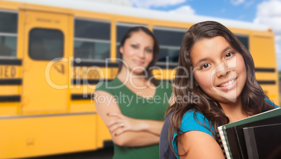 Hispanic Mother and Daughter Near School Bus.