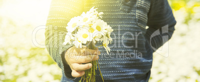 Little Child Is Holding A Bouquet Of Daisy Flower