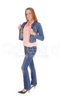 Young lady standing in jeans and jacket