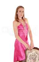 Beautiful woman standing in a long pink dress