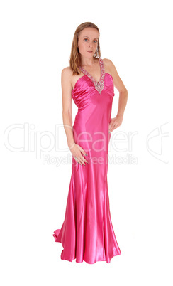 Woman standing in an pink long evening gown