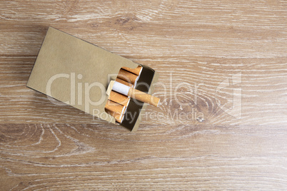 Pack of cigarettes on a wooden background