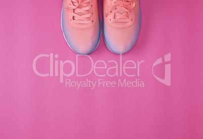 pair of  pink sneakers with  laces