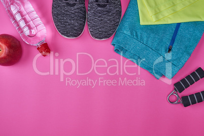 women's sportswear and fitness items on a pink background