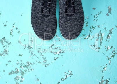 pair of black sport sneakers on green background