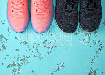 two pairs of sports sneakers on a green background