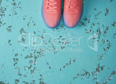 pair of  pink sneakers with  laces on a green background
