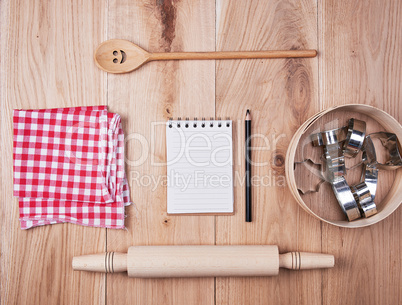 blank open notebook in line and wooden kitchen accessories, reci