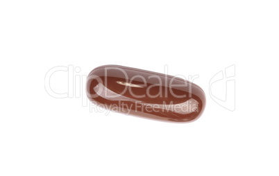 one brown gelatine pill isolated on white backgroung