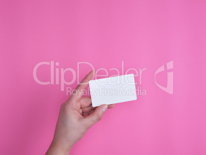 empty white rectangular business card in a female hand