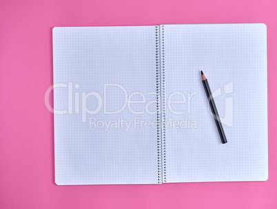 open empty  notebook in a cell on a pink background