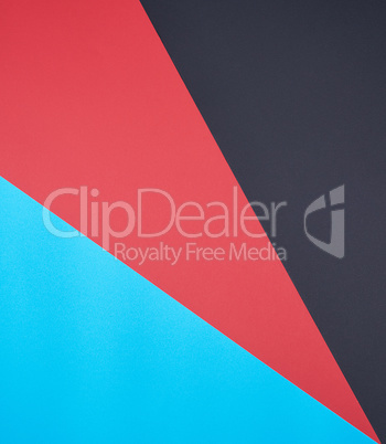 abstract background of multicolored paper, black, red and cyan c