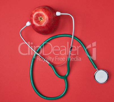 Ripe apple and green medical stethoscope