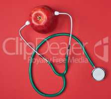Ripe apple and green medical stethoscope