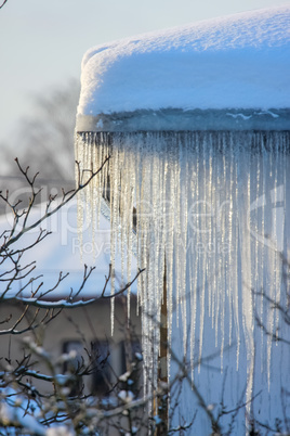 Roof with icicles hanging from roof.