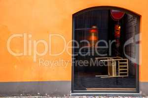 Orange wall with window in Riga.