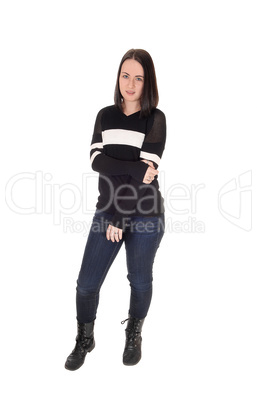 Pretty young woman standing in jeans and sweater