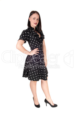 Beautiful woman standing in an pock dot black dress